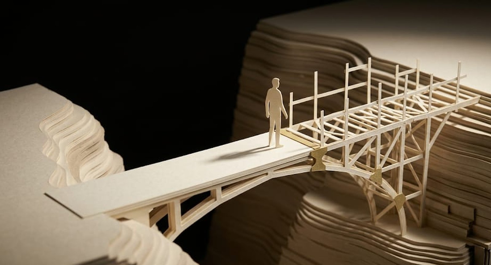 Handmade paper diorama: a person speaks through a megaphone, casting a much larger shadow